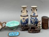 many different vases and bowls sitting on a table