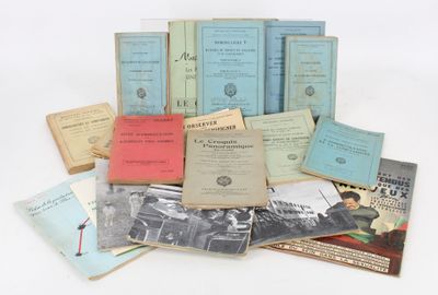 several books are stacked on top of each other on a white surface