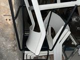 a pile of chairs and a chair that is sitting in a room