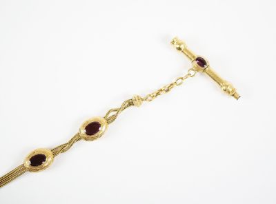 an image of a gold bracelet with garnets on it