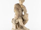an old statue of a man sitting on a rock with his hand on his chin