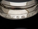 a close up of a ring on a black surface