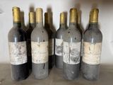 six bottles of wine are lined up in a row on a shelf