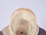 a small statue of a man with a helmet on