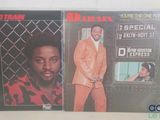 two vinyl albums of a man in a suit and a woman in a red and black shirt