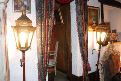 an image of a room with a lamp and pictures on the wall