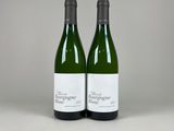 two bottles of wine sitting on top of a white table