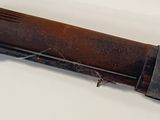 an old gun that is laying on a white surface