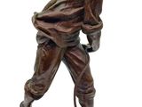bronze figurine of a man with a dog on a rock