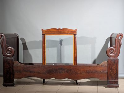 un lit en bois surmonté d'un miroir
