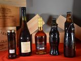 many bottles of wine sitting on a red table cloth