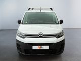 the white van is parked in a large room with a black floor