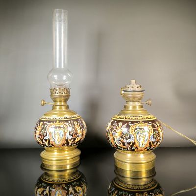 une paire de lampes dorées et noires posées sur une table noire, sur fond blanc