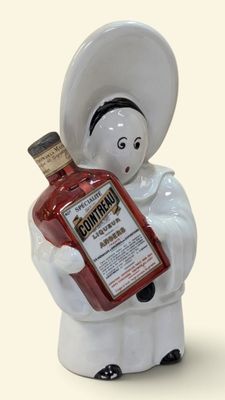 a figurine of a woman holding a bottle of liquor