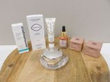 a wooden table with a lot of cosmetics and a bottle of lotion