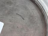 a silver plate with a card in it on a table