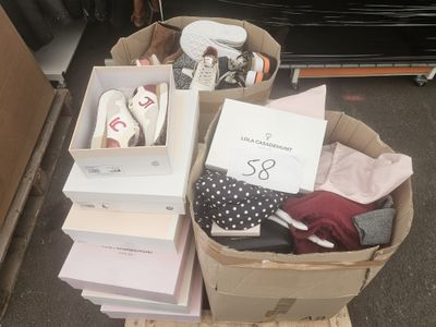 many boxes of clothes and shoes on the floor