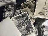 several old black and white photos of people and buildings on a table