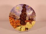 a plate with a painting of a landscape on it