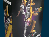une boîte contenant une figurine Lego représentant un squelette tenant une banane