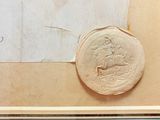 a picture of a wax seal on a piece of paper