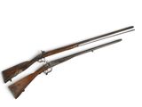 a pair of two guns are shown on a white surface