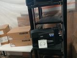 a rack with many different types of printers on it