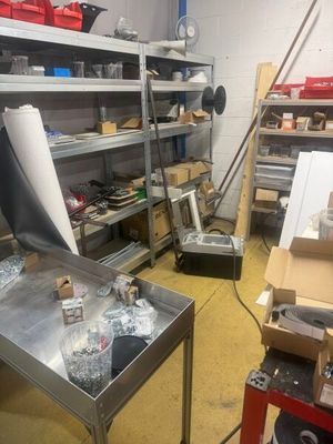 a metal table with a sheet of paper on top of it in a room