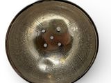 a small metal bowl with a lid on a white surface