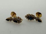 two pairs of earrings with blue stones on them