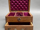 an open wooden box with a wine glass inside of it