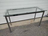 a glass table with a metal frame on it