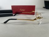 cartier eyeglasses with gold trim and clear lenses on a table