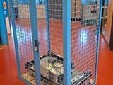 a blue cage with a computer inside of it