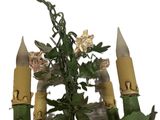 a candle holder with a bunch of flowers on it