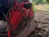 a tractor that is parked in the dirt