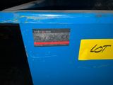 a blue trash can with a yellow sticker on it
