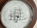 a clock on the wall that has a ship on it