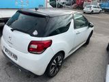 a small white car parked in a parking lot