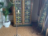 a tall stand with a bunch of decorative objects on it