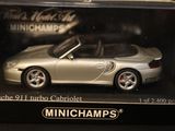 a silver toy car in a box on a table