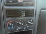 the dashboard of a car with a clock and radio in it