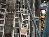 many chairs and ladders in a building under construction