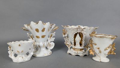 three white vases with gold designs on them on a gray surface