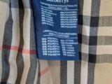 a close up of a burberry shirt with a blue label on it