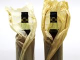 two bottles of wine wrapped in a plastic bag