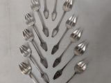 a lot of silver spoons and forks arranged in a circle