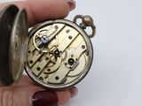 a person holding a pocket watch in their hand