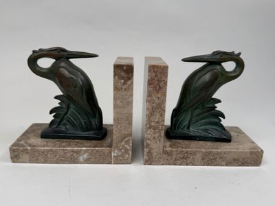 pair of bronze bookends with a bird on a leafy base