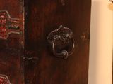a wooden cabinet with a door and a clock on the wall